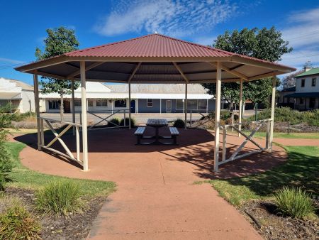 Seating sheltered under rotunda with path leading to it