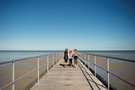 Three young children walking up Port Germein Jetty